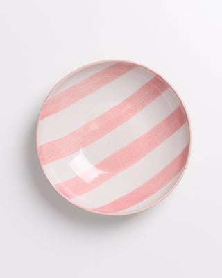 Keramikschale mit rosa und weißen Streifen auf hellem Hintergrund.