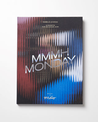 Buchcover mit einem abstrakten, wellenförmigen Muster in Rot, Blau und Weiß, der Titel "MMMHH MONDAY" in großen Buchstaben.
